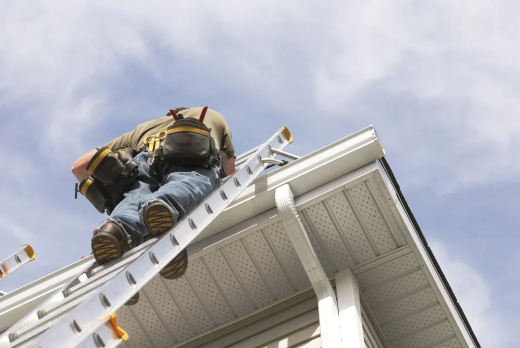 Worker inspecting gutters