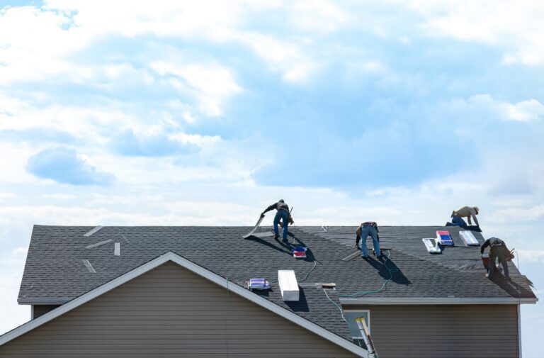 Workers on roof repairing