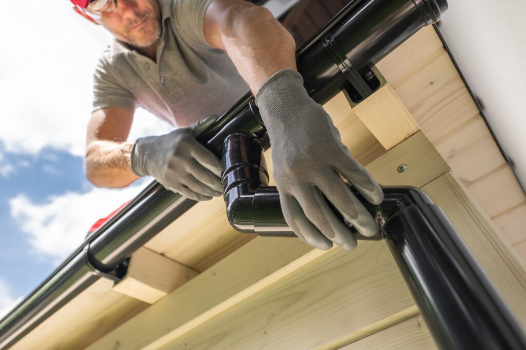 worker fixing gutter