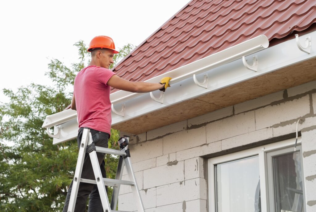 Worker installing gutter