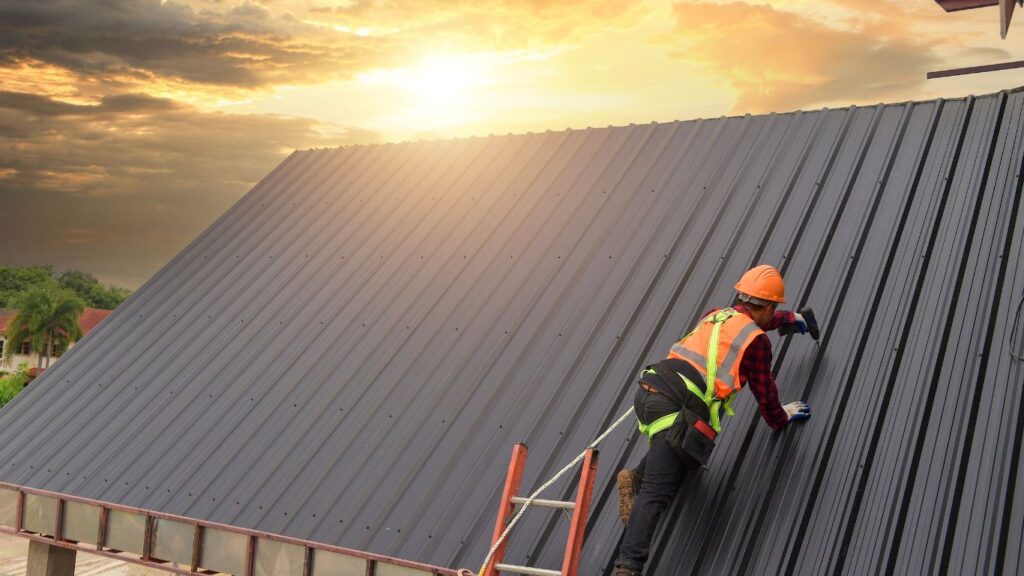 metal roofing installation with sunset in background